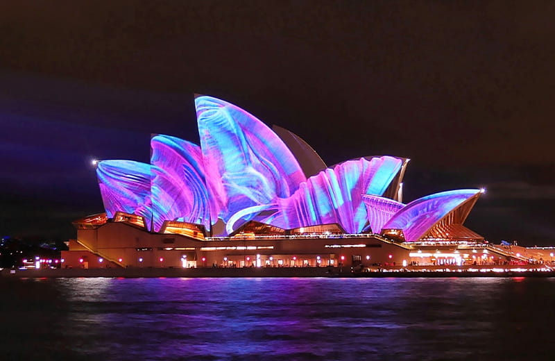See the beautiful Opera House clad in the vibrant lights of Vivid Sydney.