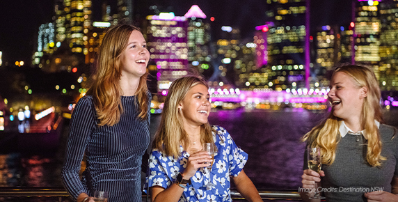 Festival-goers enjoying the Vivid Sydney atmosphere on Sydney Harbour aboard a boat